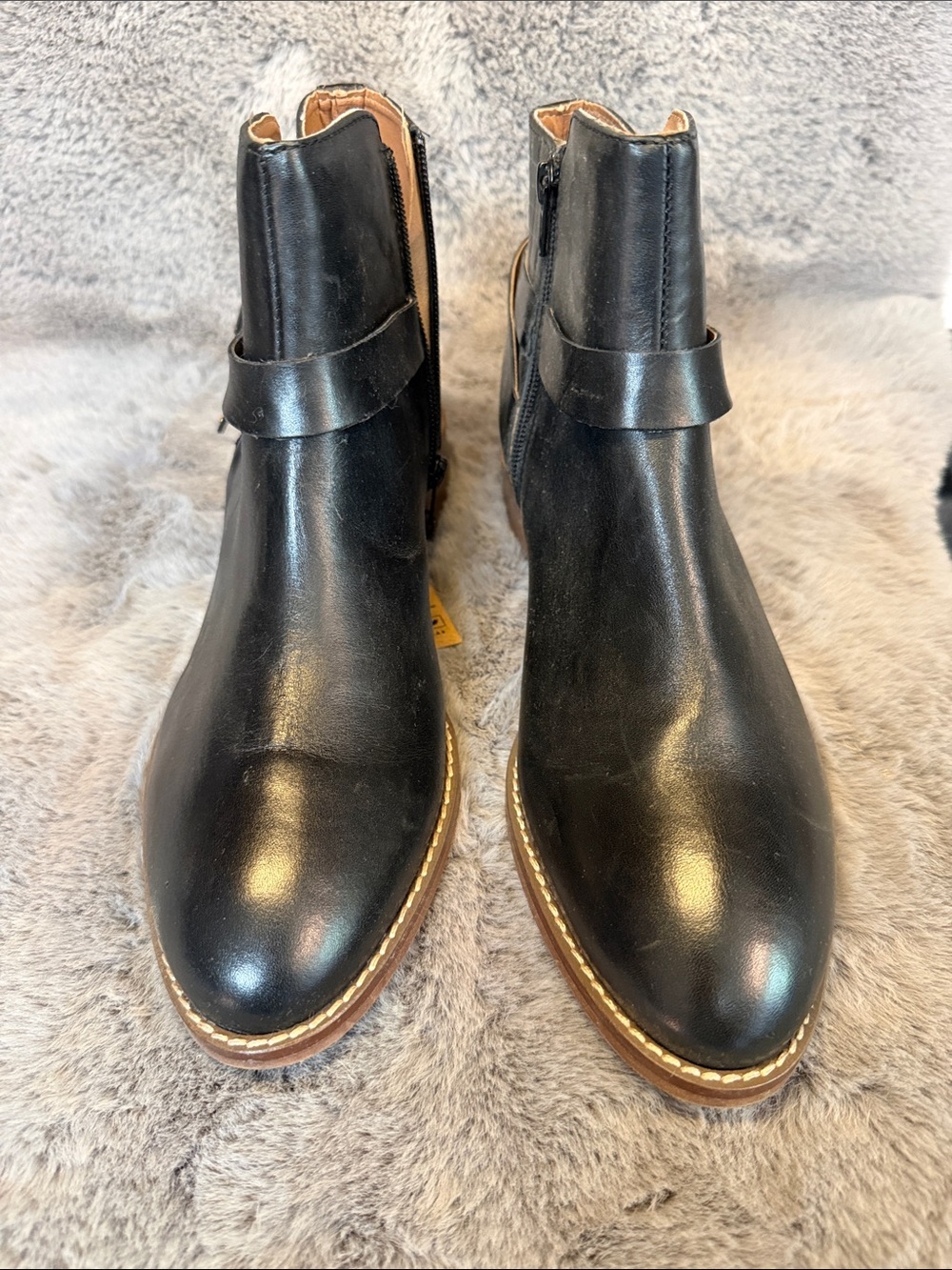 Black leather ankle boots with gold trim